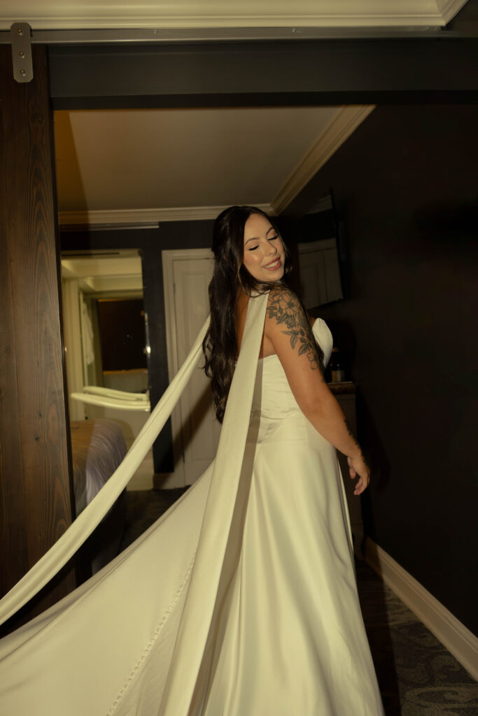 Bride has just gotten ready and is showing off her look to her bridesmaids and mom