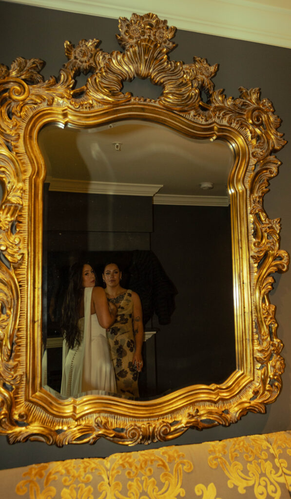 bride and twin sister of the bride are having a moment as they look one last time before she walks down the aisle 